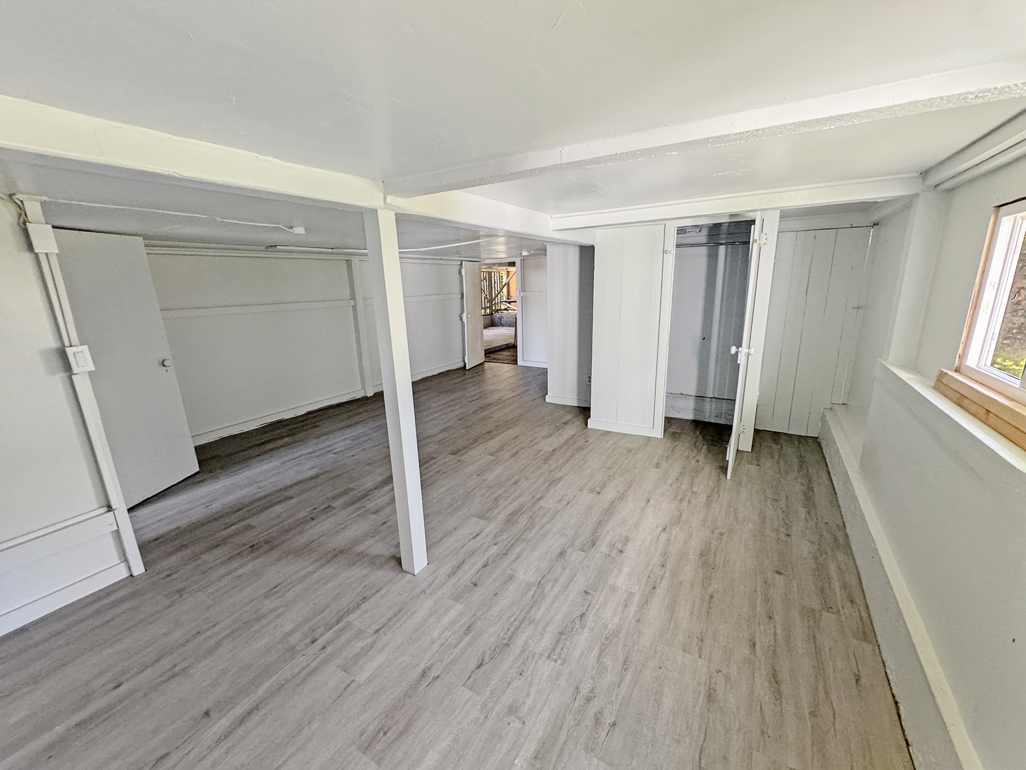 136 Mauna Loa Street Hilo, HI 96720 - Photo 13 of 23 an empty room with wooden floor and windows