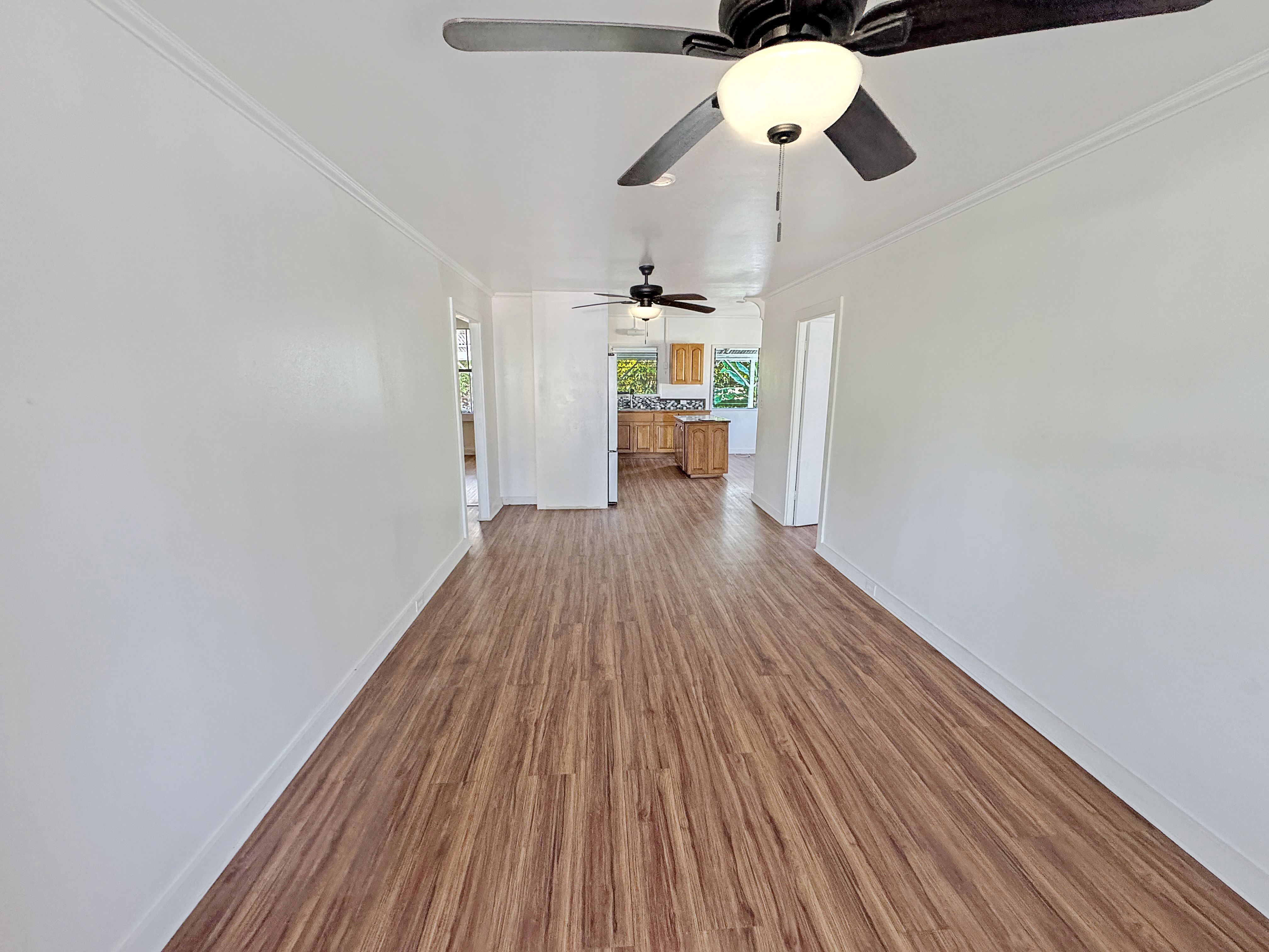 136 Mauna Loa Street Hilo, HI 96720 - Photo 3 of 23 a view of a room with wooden floor ceiling fan