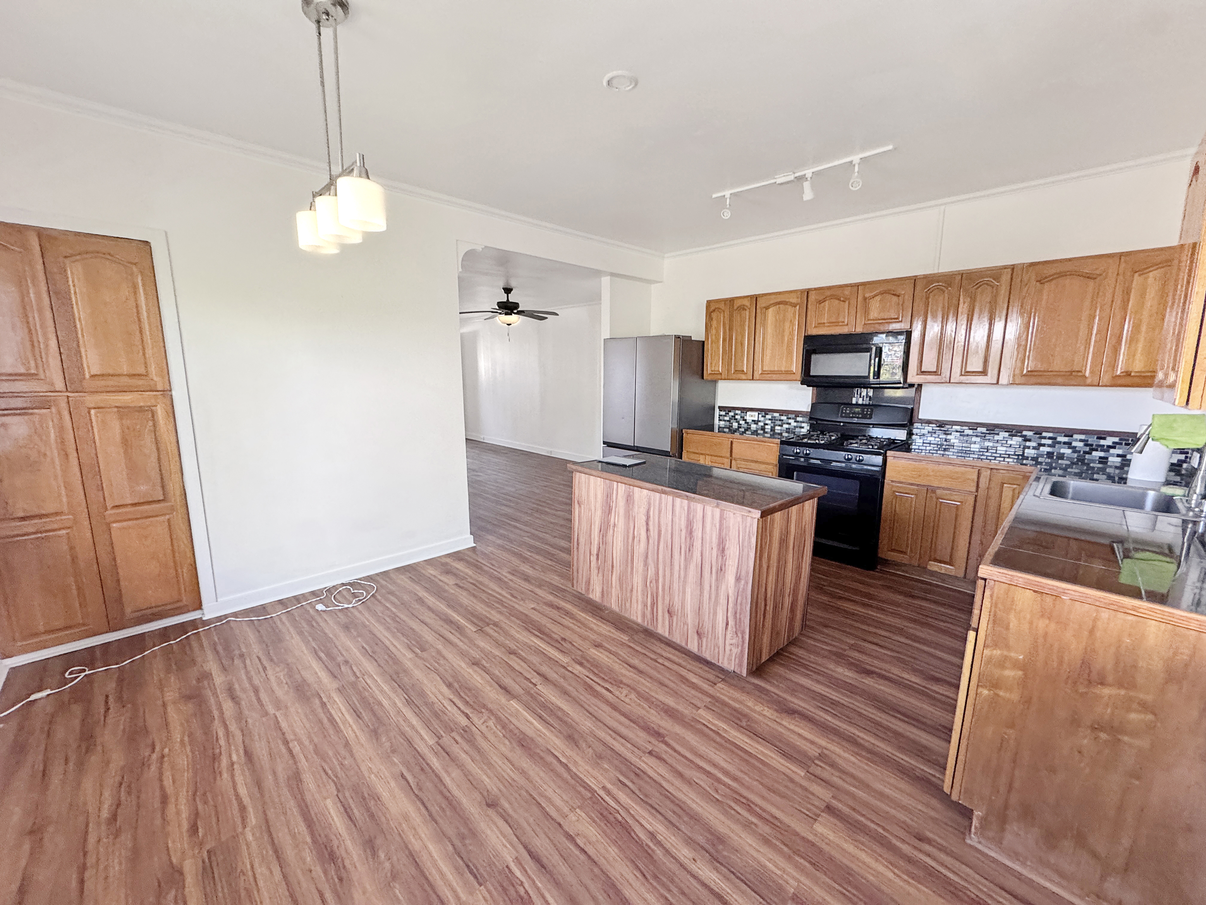 136 Mauna Loa Street Hilo, HI 96720 - Photo 5 of 23 a kitchen with stainless steel appliances granite countertop a refrigerator a sink dishwasher a stove and a wooden floor