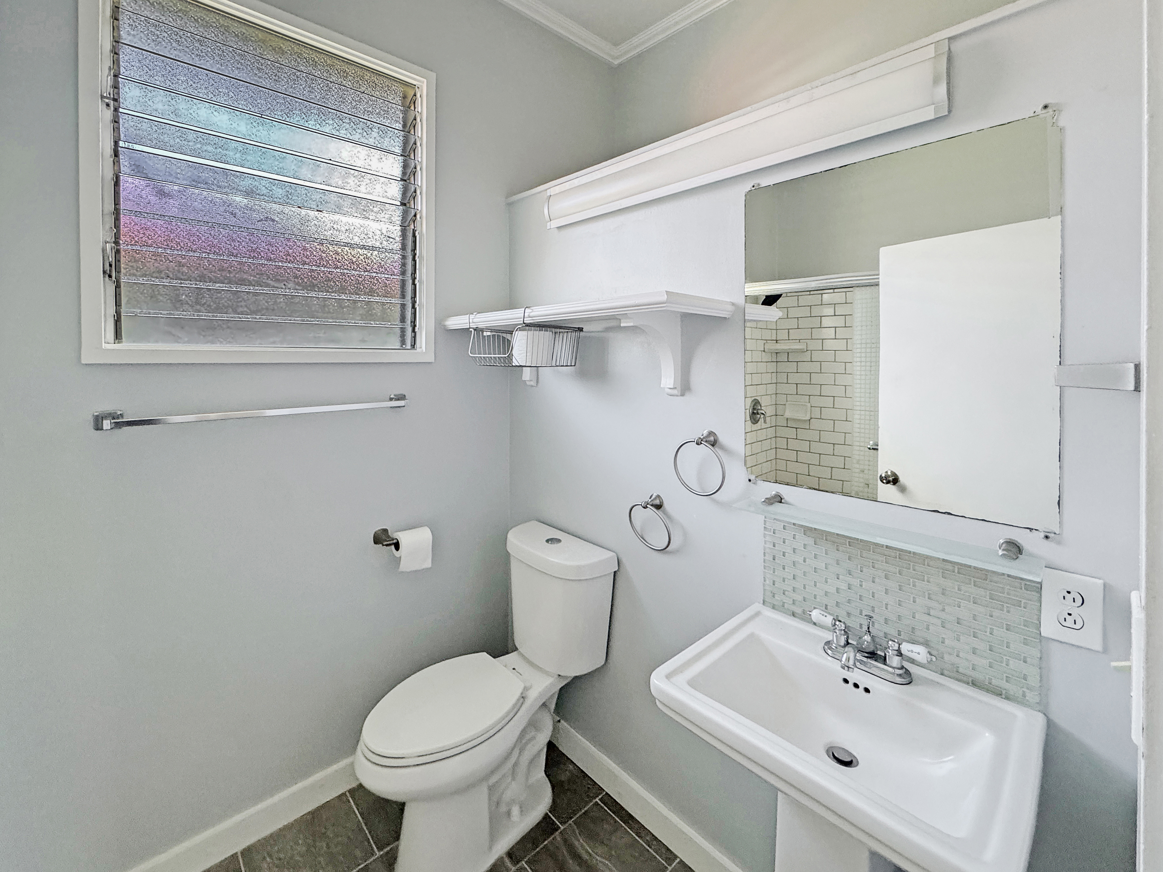 136 Mauna Loa Street Hilo, HI 96720 - Photo 6 of 23 a bathroom with a toilet sink and mirror