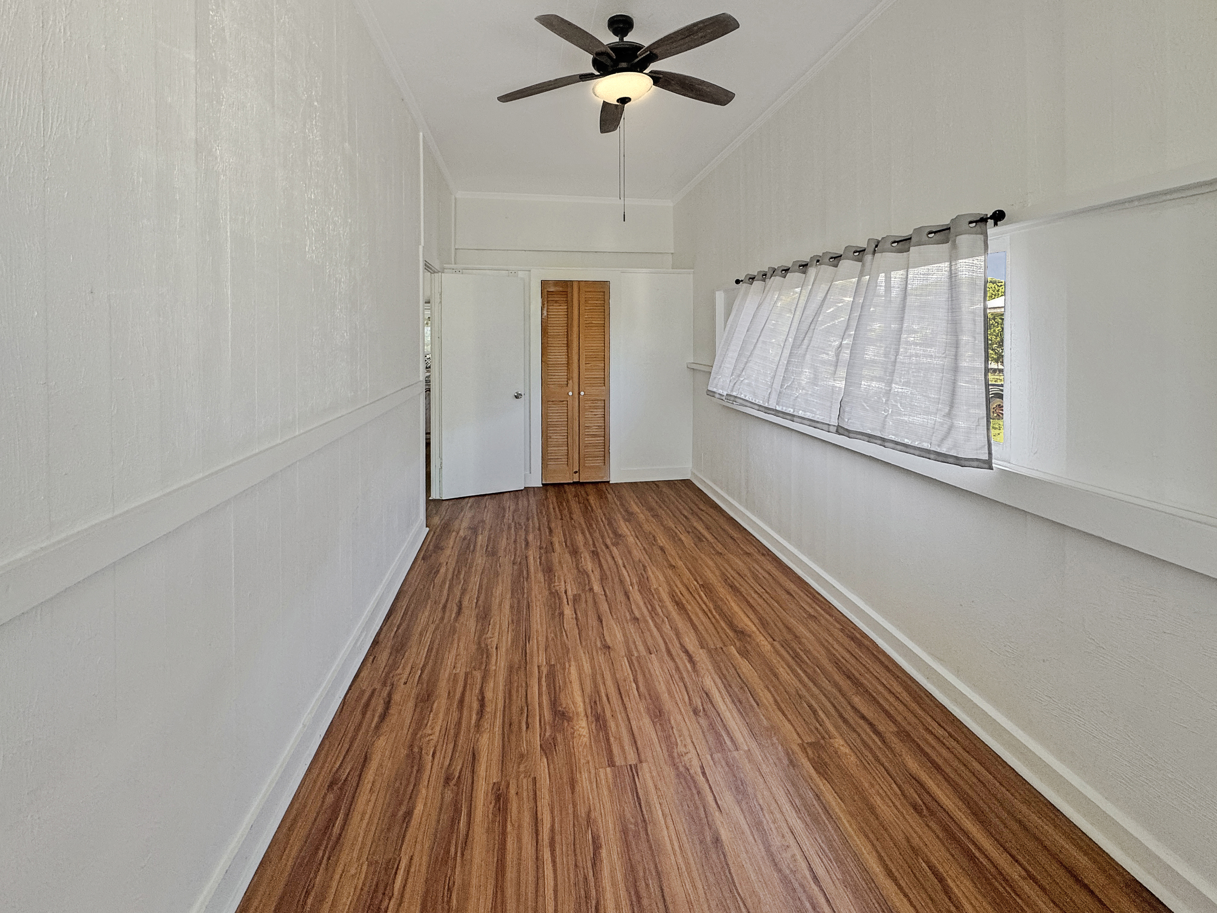 136 Mauna Loa Street Hilo, HI 96720 - Photo 9 of 23 wooden floor in an empty room with a window