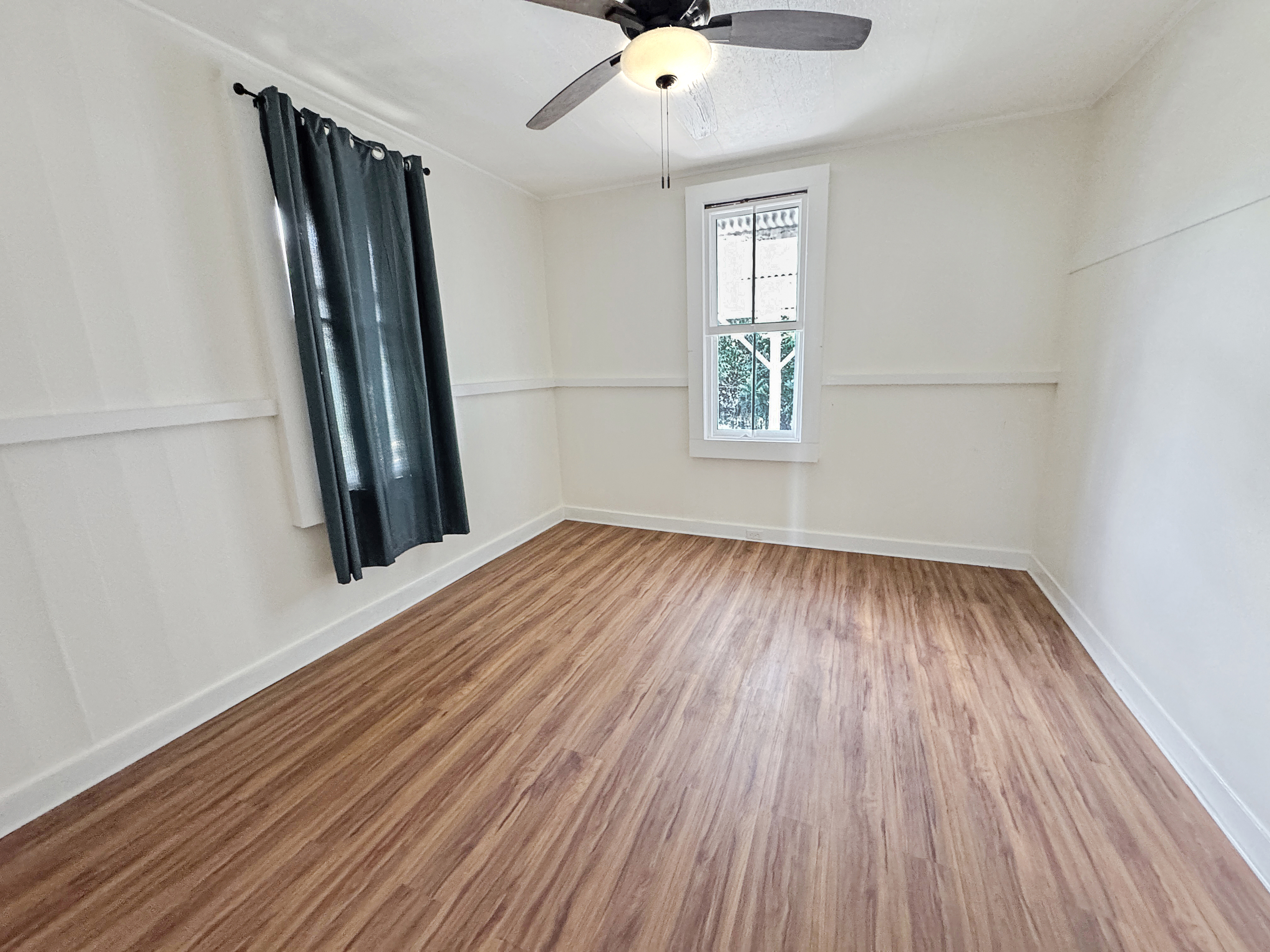 136 Mauna Loa Street Hilo, HI 96720 - Photo 10 of 23 wooden floor in an empty room with a window
