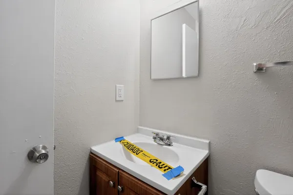 a bathroom with a sink toilet and mirror