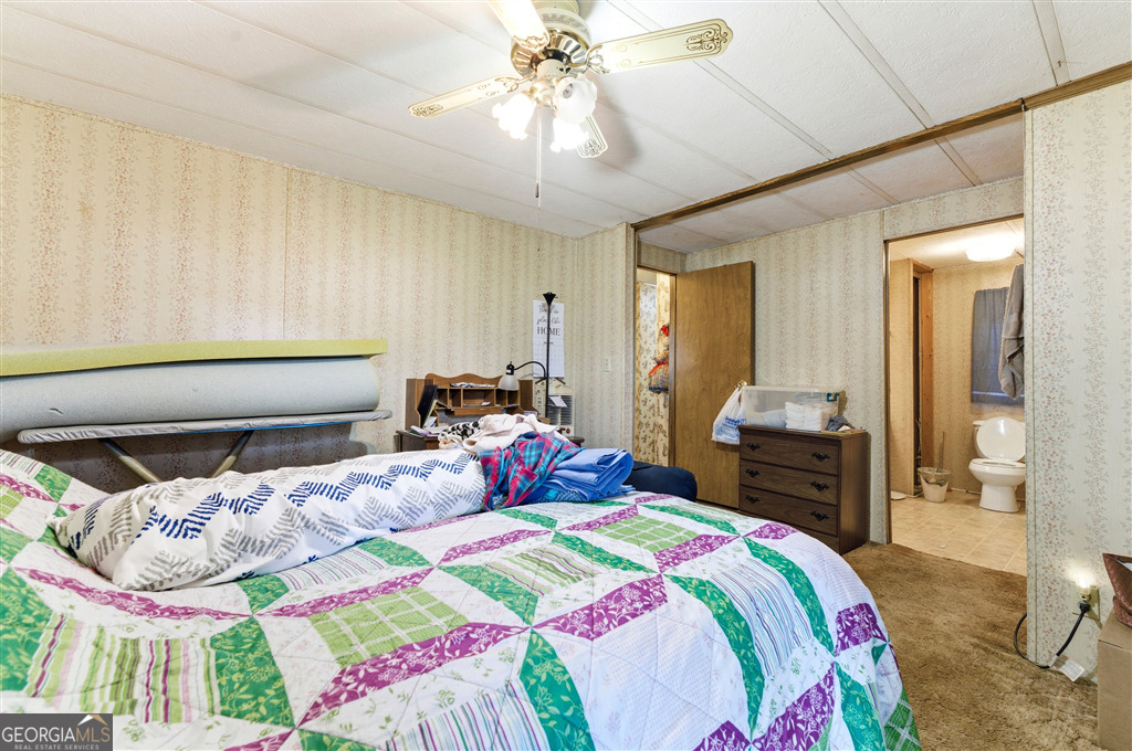 85 Honeysuckle Drive Southwest Cartersville, GA 30120 - Photo 12 of 20 a bedroom with bed and a chandelier