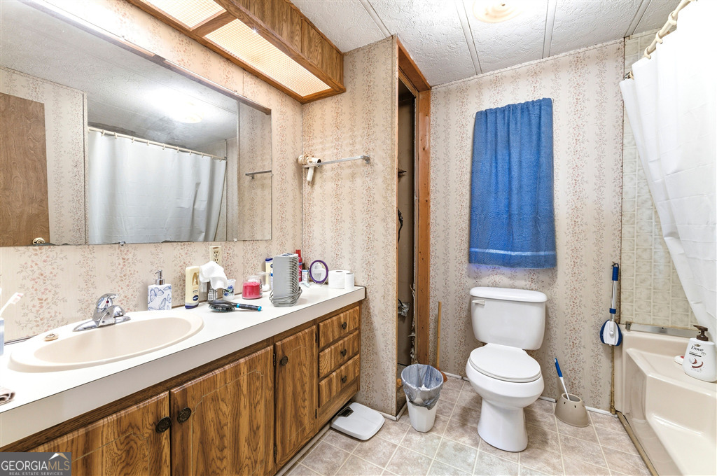 85 Honeysuckle Drive Southwest Cartersville, GA 30120 - Photo 13 of 20 a bathroom with a sink toilet and shower