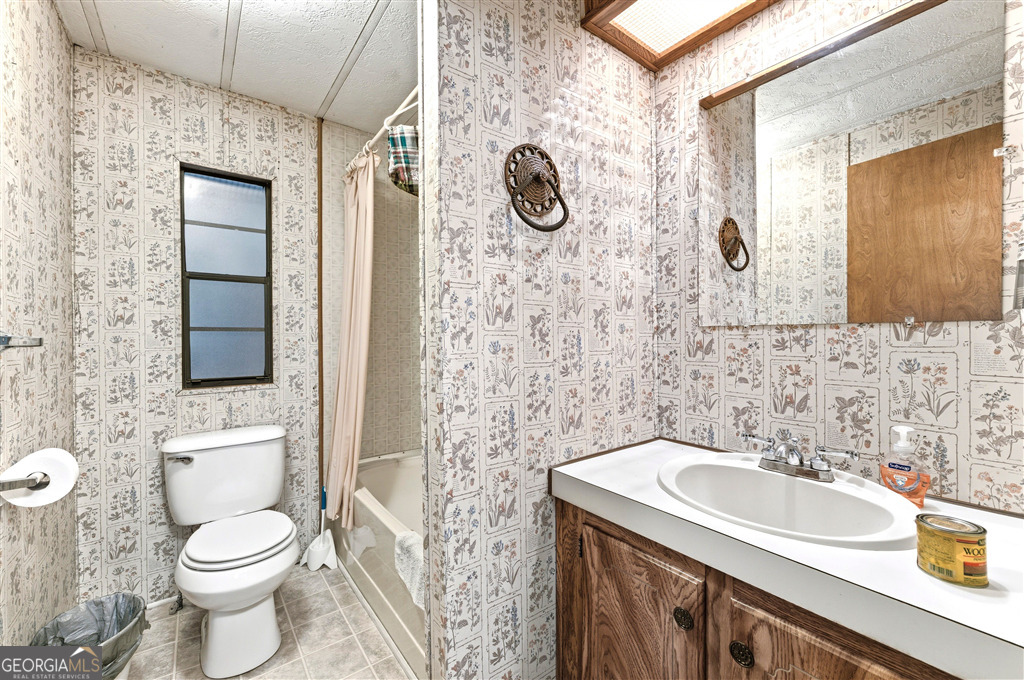 85 Honeysuckle Drive Southwest Cartersville, GA 30120 - Photo 14 of 20 a bathroom with a sink toilet and shower
