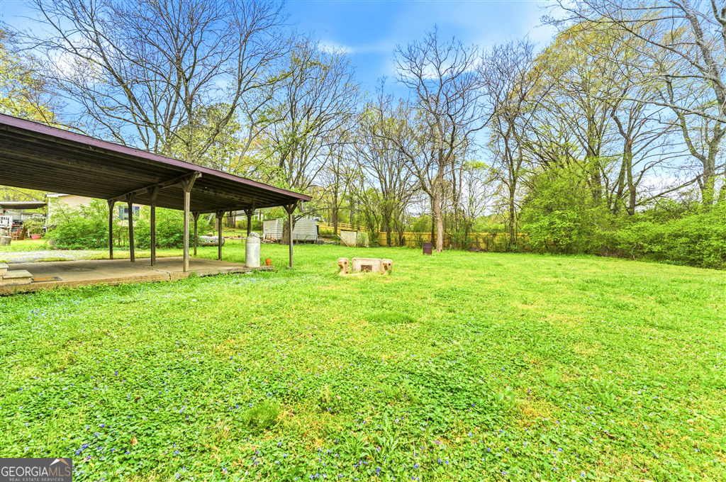 85 Honeysuckle Drive Southwest Cartersville, GA 30120 - Photo 19 of 20 a view of a backyard with a garden and trees