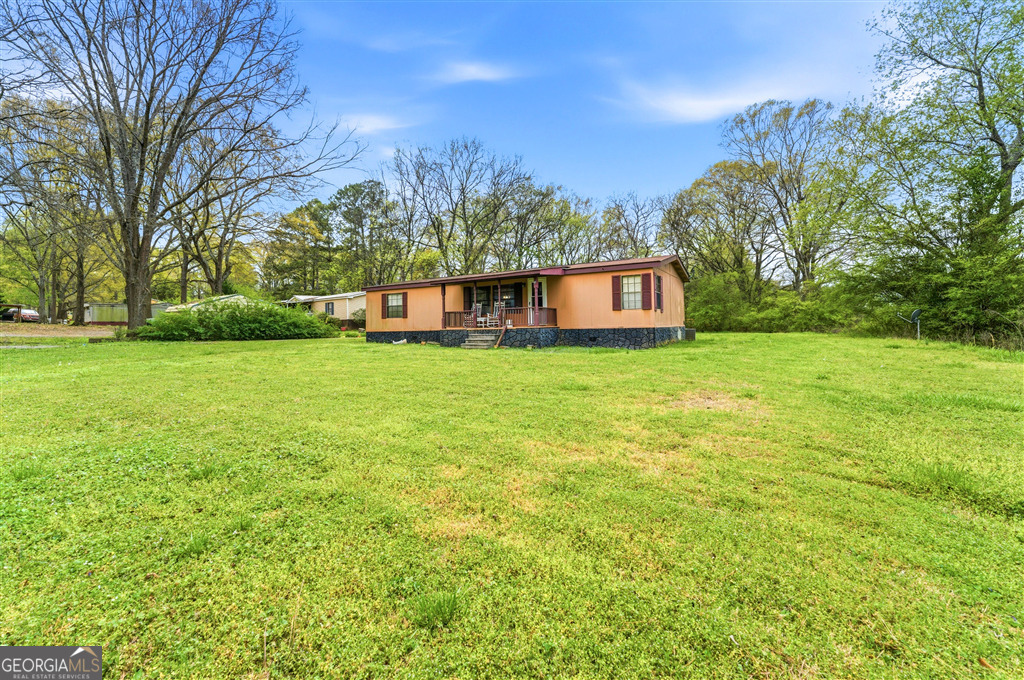 85 Honeysuckle Drive Southwest Cartersville, GA 30120 - Photo 2 of 20 a view of a big yard with large trees