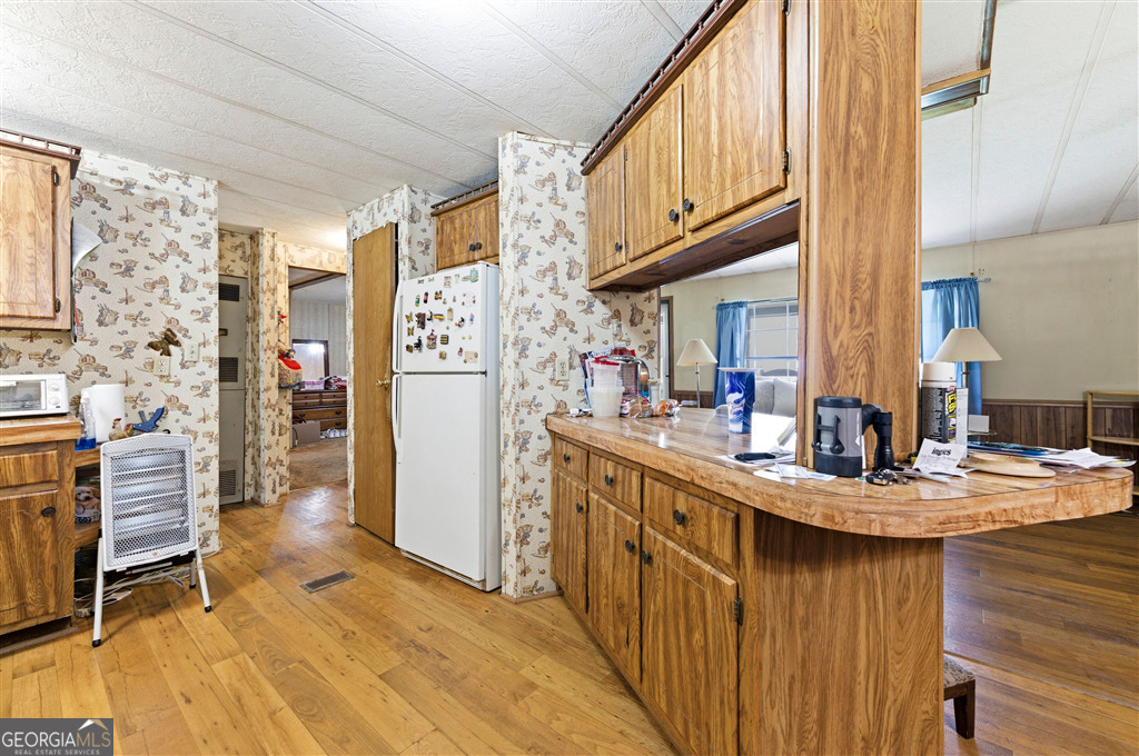 85 Honeysuckle Drive Southwest Cartersville, GA 30120 - Photo 8 of 20 a kitchen with stainless steel appliances granite countertop a refrigerator a stove and a sink with cabinets