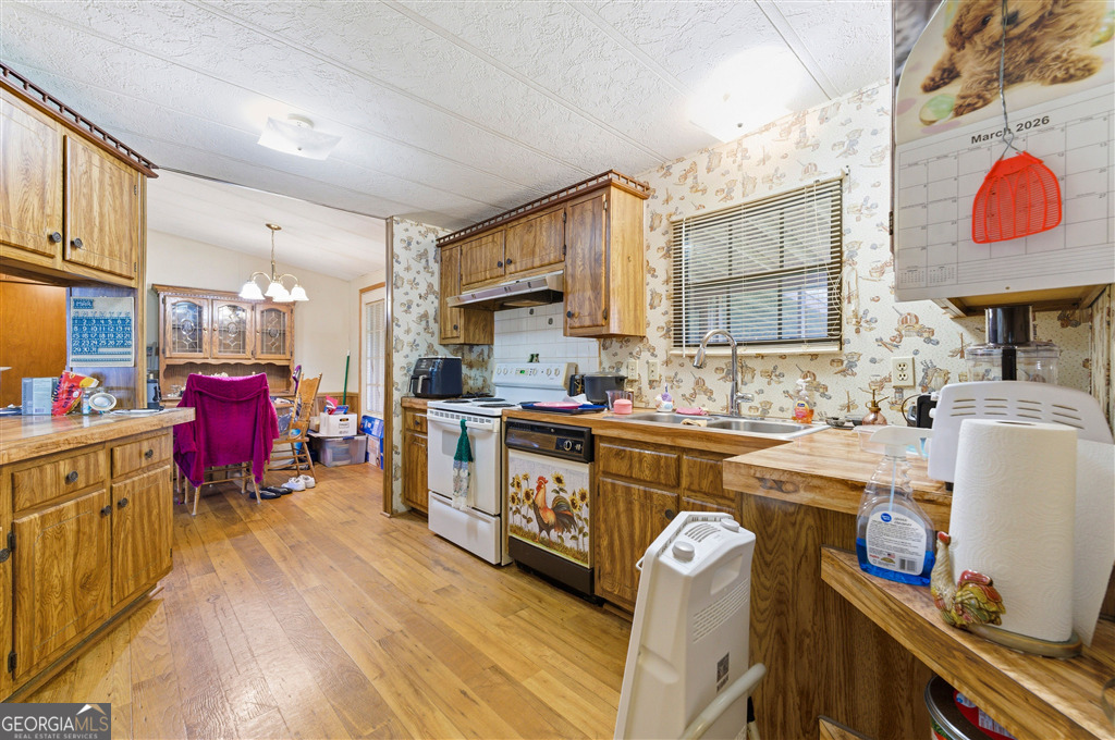 85 Honeysuckle Drive Southwest Cartersville, GA 30120 - Photo 9 of 20 a kitchen that has a lot of cabinets a sink and a wooden floor