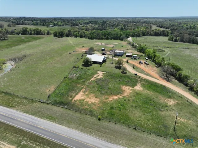 an aerial view of a house with a yard
