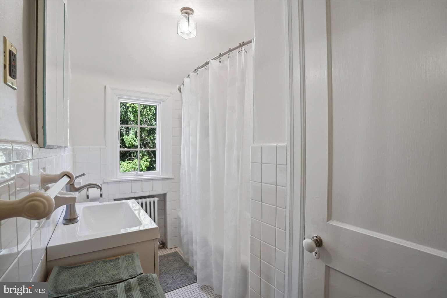273 Strafford Avenue Wayne, PA 19087 - Photo 24 of 42 a bathroom with a sink a bathtub and a window