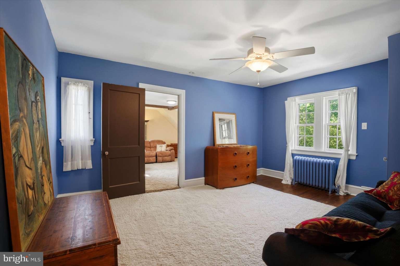 273 Strafford Avenue Wayne, PA 19087 - Photo 25 of 42 a bedroom with a bed and a chandelier