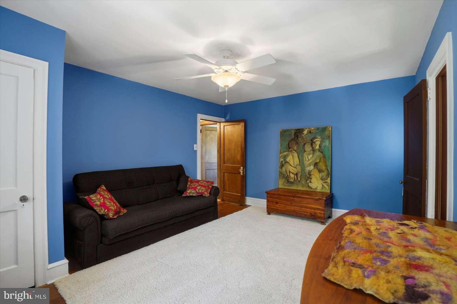 273 Strafford Avenue Wayne, PA 19087 - Photo 26 of 42 a bedroom with a bed and a chandelier
