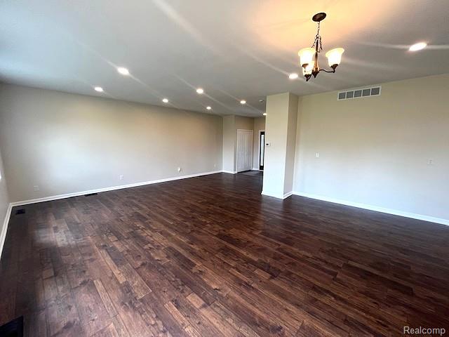 2670 Riley Center Road Memphis, MI 48041 - Photo 10 of 24 Spacious room with wood-finish flooring, recessed lighting, and a decorative chandelier