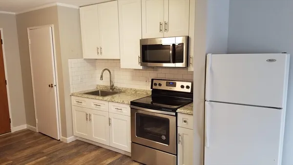 a kitchen with stainless steel appliances a refrigerator stove and microwave