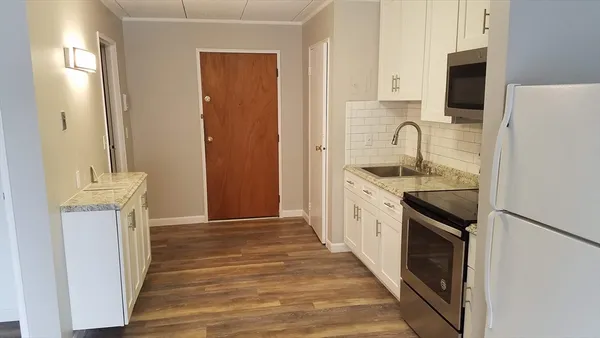 a kitchen with a sink stove and refrigerator