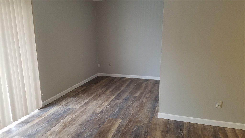 40 Cochituate Road, Unit 40 Framingham, MA 01701 - Photo 9 of 12 a view of a small space with wooden floor and a window