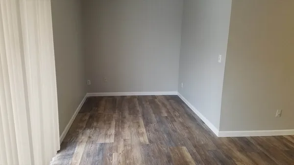 a view of a room with wooden floor