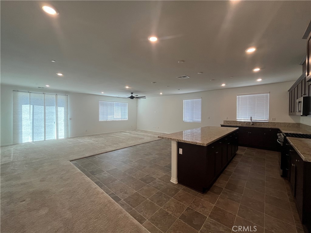 5233 Saloon Street Hemet, CA 92545 - Photo 11 of 18 a living room with kitchen island furniture and a window
