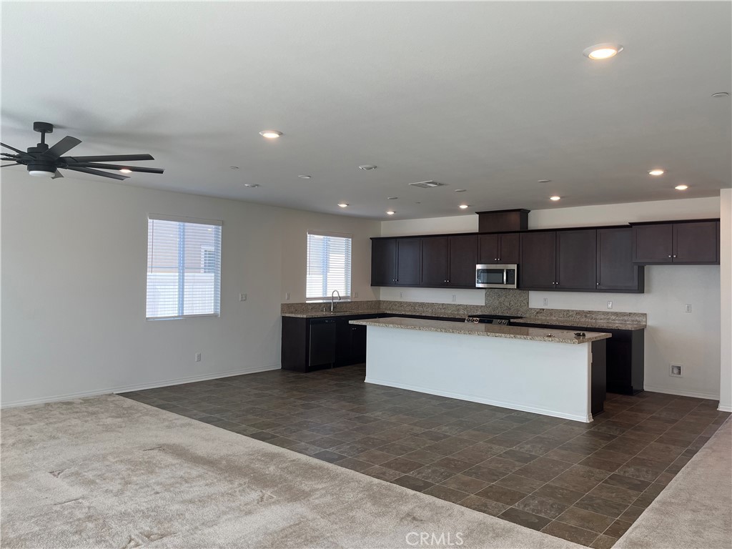 5233 Saloon Street Hemet, CA 92545 - Photo 4 of 18 a large kitchen with a refrigerator a sink dishwasher a stove and a refrigerator with wooden floor