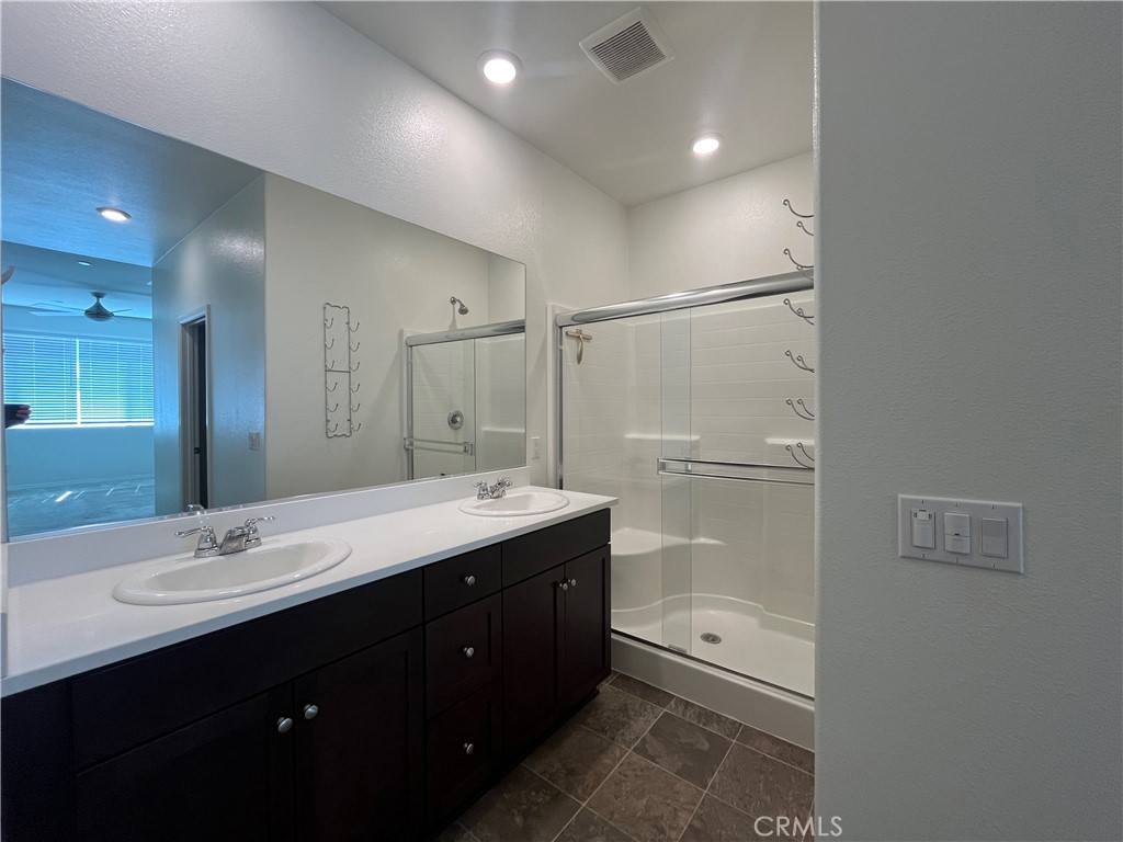 5233 Saloon Street Hemet, CA 92545 - Photo 7 of 18 a bathroom with a double vanity sink toilet and shower