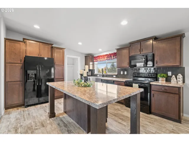 a kitchen with counter top space sink and stainless steel appliances