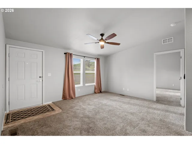 a view of an empty room with a window