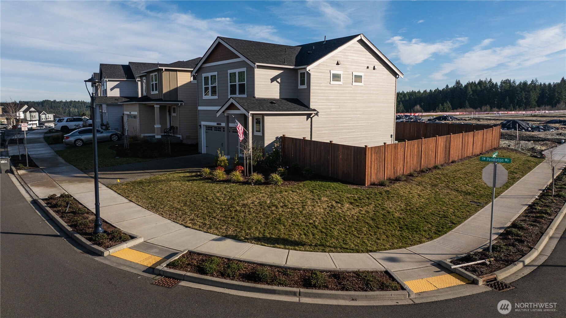 1164 Southwest Pendleton Way Port Orchard, WA 98367 - Photo 24 of 32 a view of a white house with a yard and potted plants