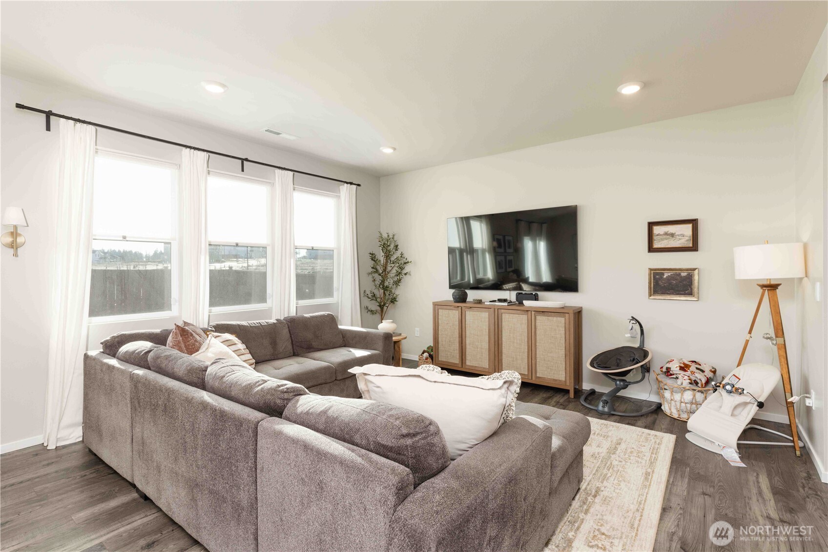 1164 Southwest Pendleton Way Port Orchard, WA 98367 - Photo 6 of 32 a living room with furniture a flat screen tv and a large window