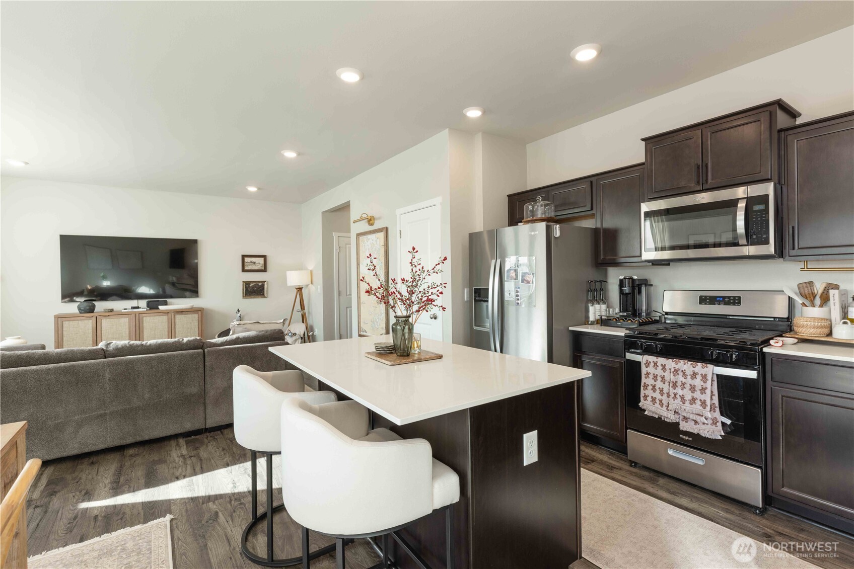 1164 Southwest Pendleton Way Port Orchard, WA 98367 - Photo 10 of 32 a kitchen with stainless steel appliances granite countertop a stove a refrigerator a microwave a sink and white cabinets with wooden floor