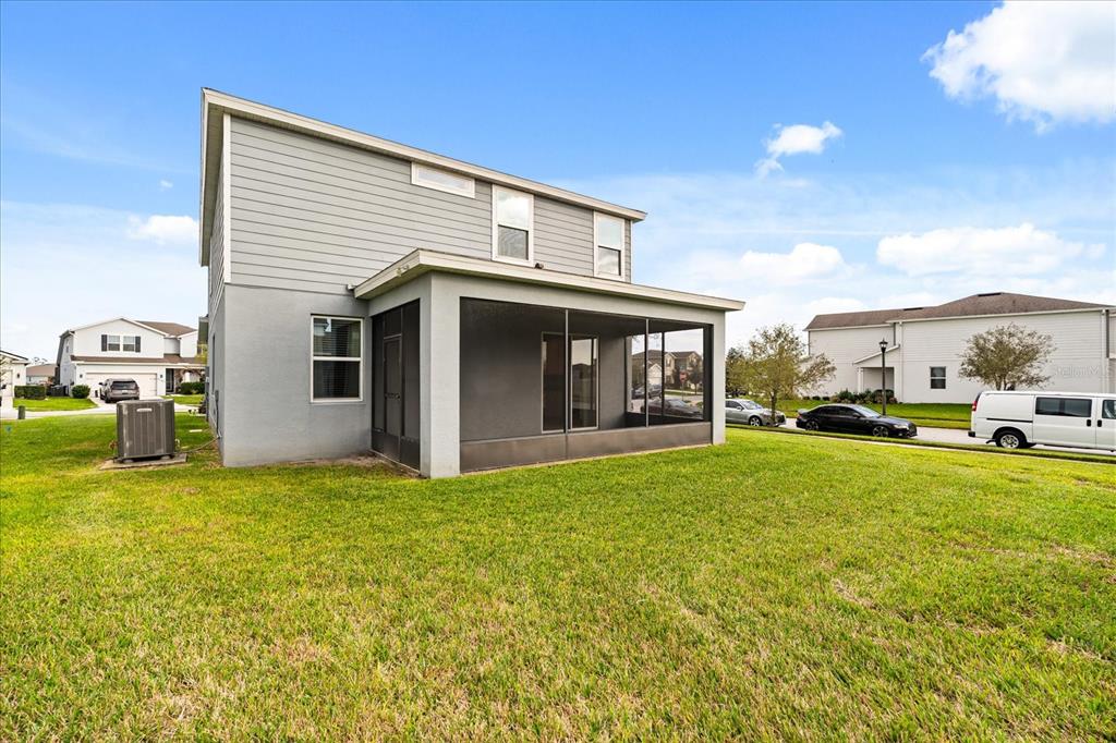 5192 Chickadee Street St. Cloud, FL 34771 - Photo 34 of 35 a view of a house with backyard porch and garden