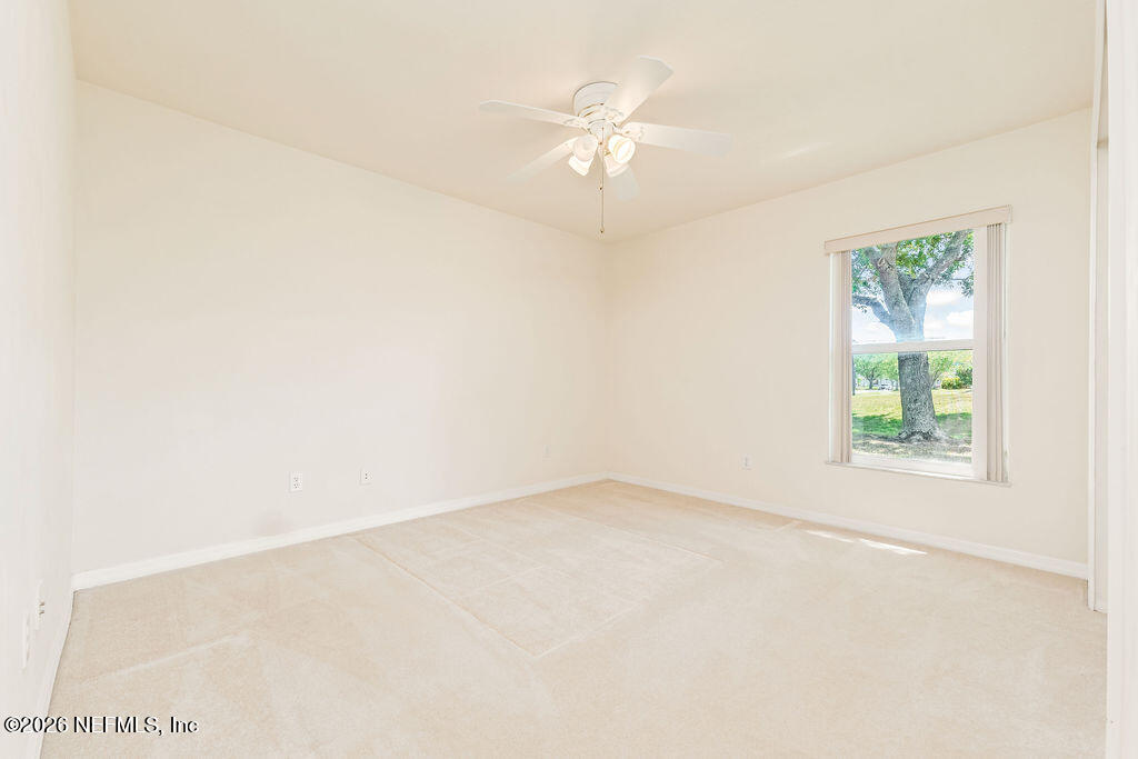 8 Peruvian Lane Ormond Beach, FL 32174 - Photo 18 of 40 an empty room with a fan and a window