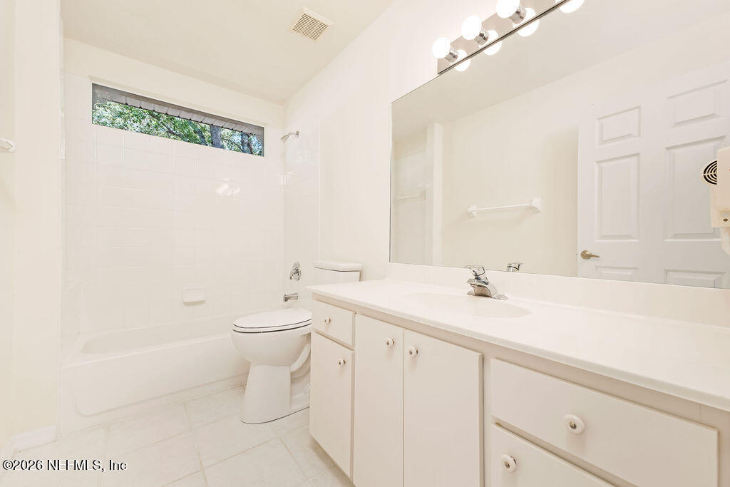 8 Peruvian Lane Ormond Beach, FL 32174 - Photo 20 of 40 a bathroom with a granite countertop sink a toilet and a mirror