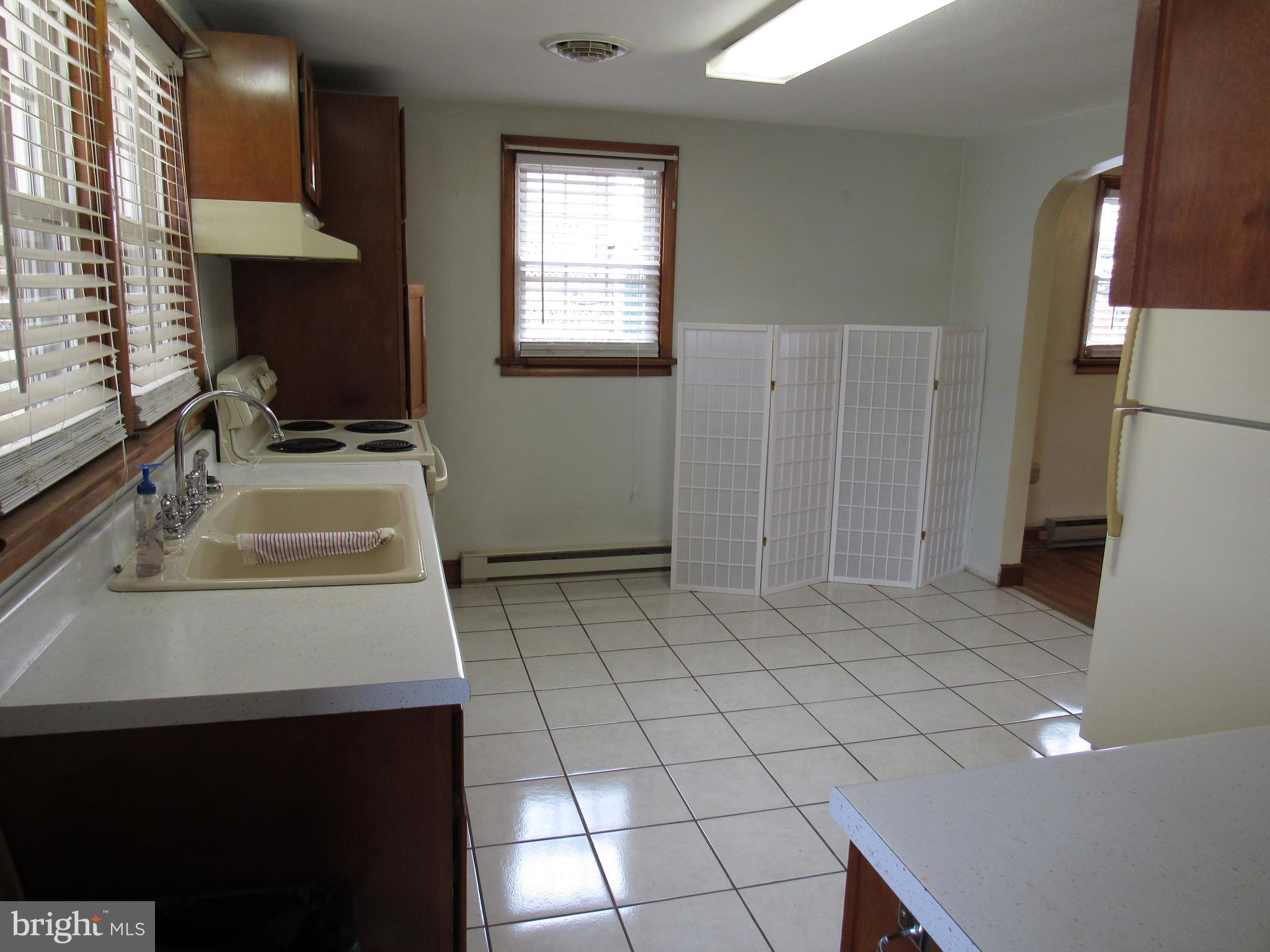 110 West 6th Avenue Ranson, WV 25438 - Photo 11 of 27 a bathroom with a sink a toilet and mirror