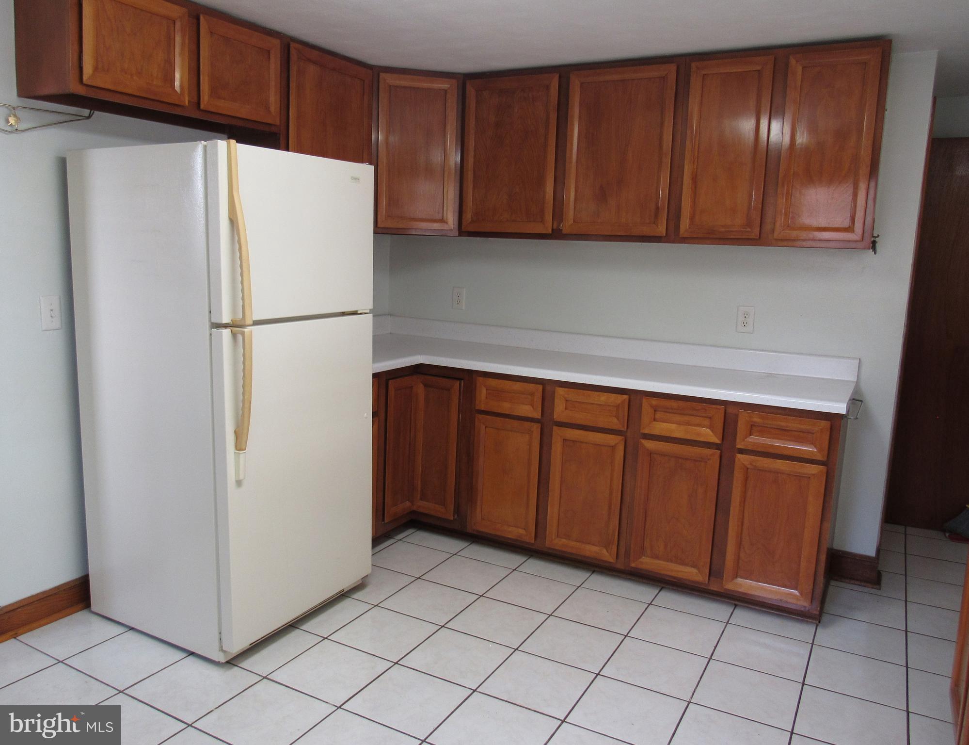 110 West 6th Avenue Ranson, WV 25438 - Photo 12 of 27 a white refrigerator freezer sitting in a kitchen