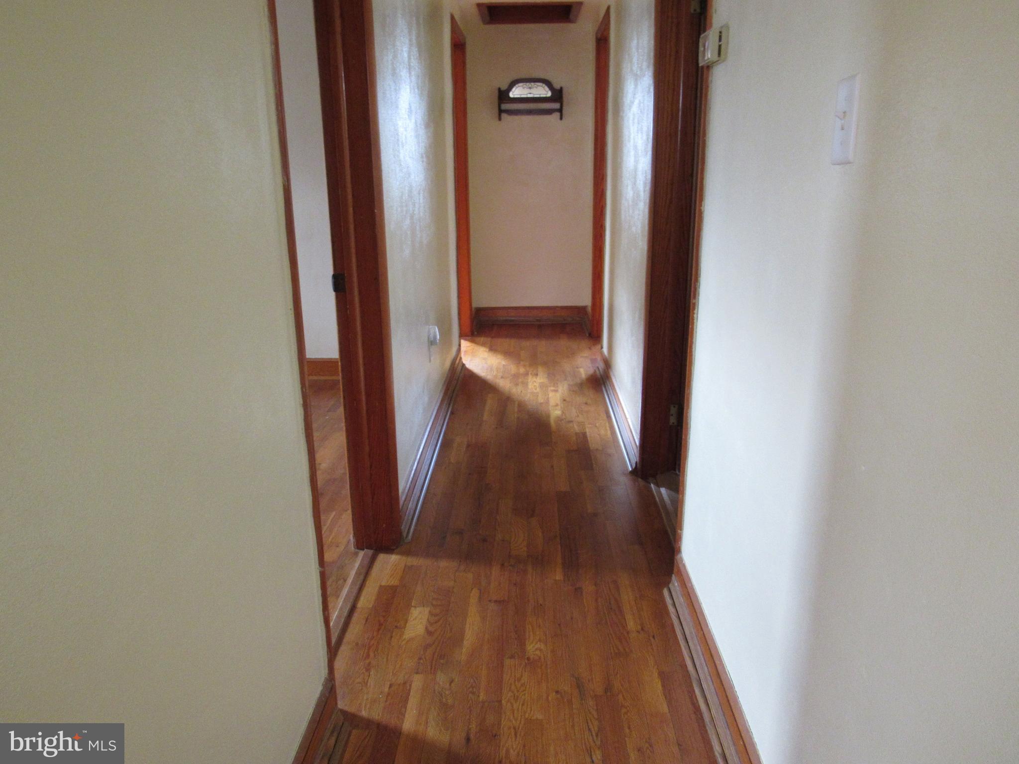 110 West 6th Avenue Ranson, WV 25438 - Photo 13 of 27 a view of a hallway with wooden floor
