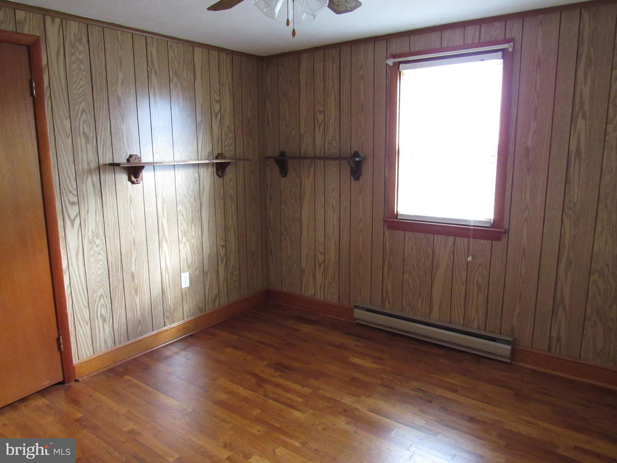 110 West 6th Avenue Ranson, WV 25438 - Photo 15 of 27 an empty room with wooden floor and a window