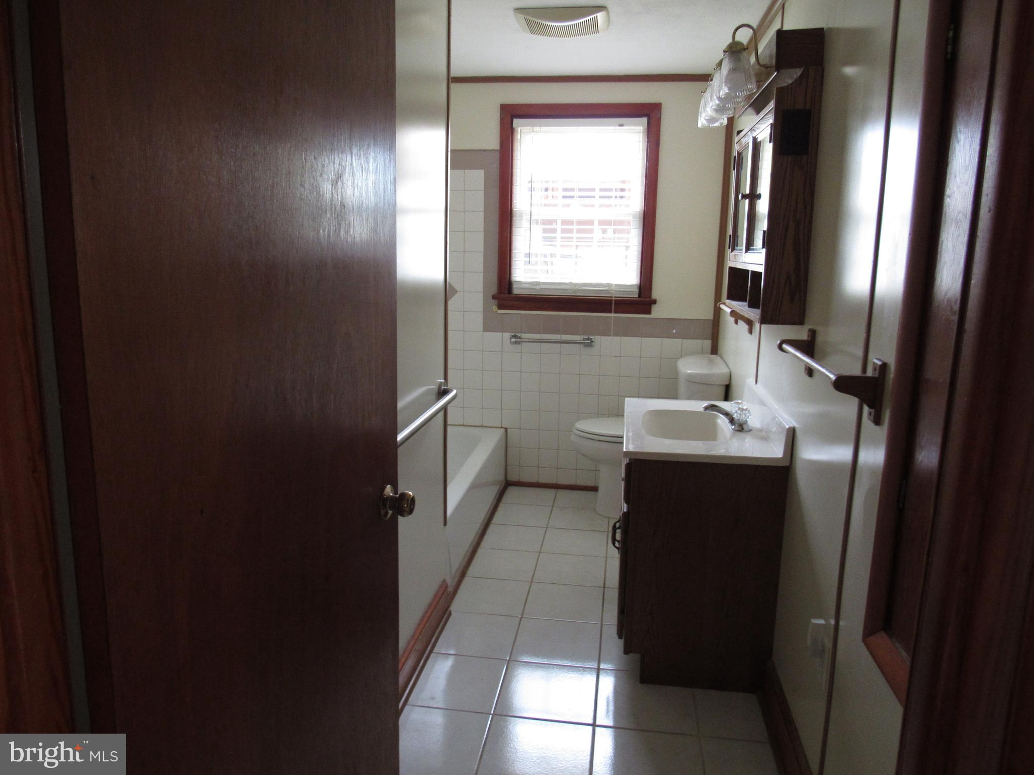 110 West 6th Avenue Ranson, WV 25438 - Photo 17 of 27 a bathroom with a sink vanity and mirror