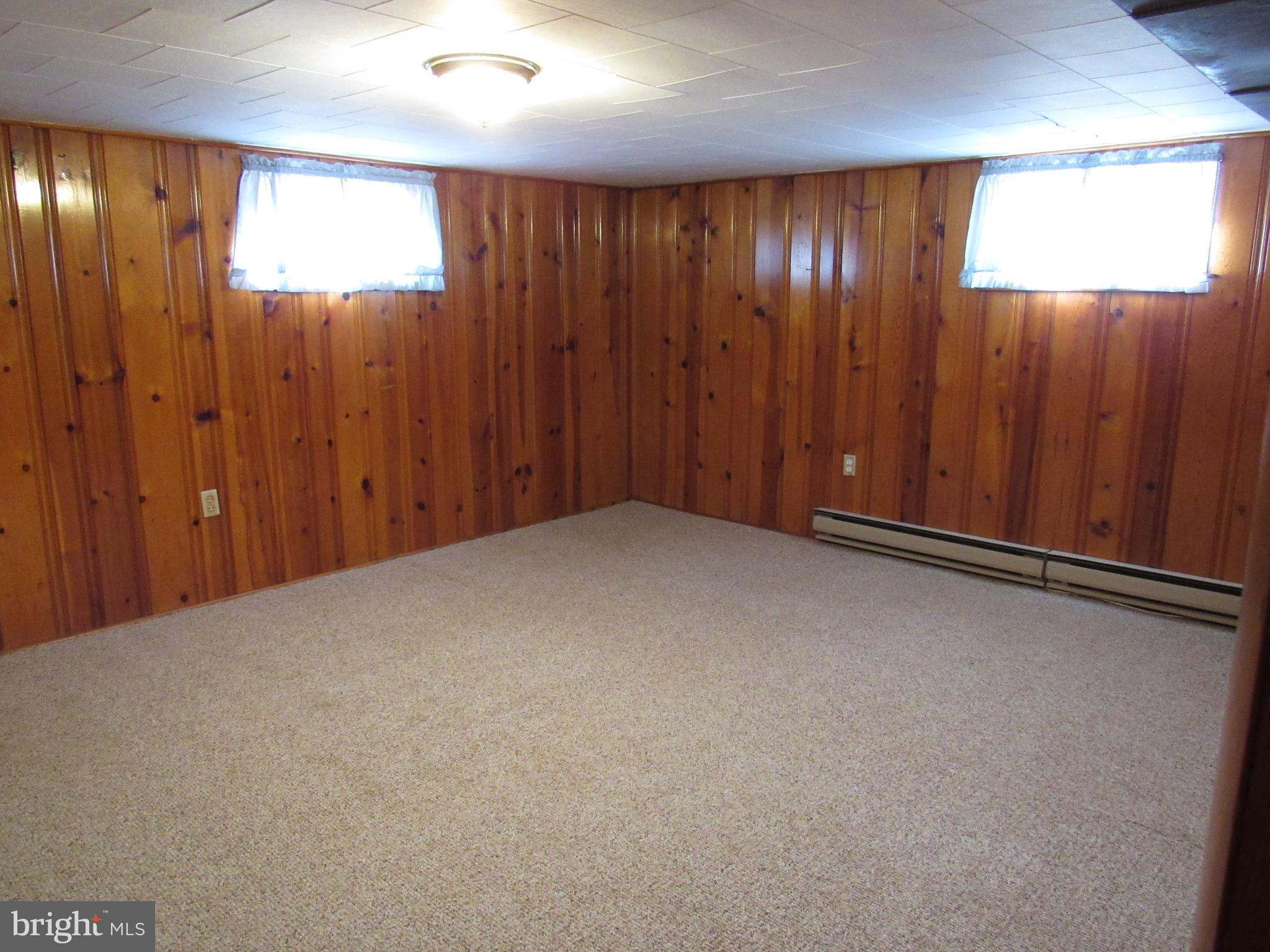 110 West 6th Avenue Ranson, WV 25438 - Photo 24 of 27 an empty room with wooden walls