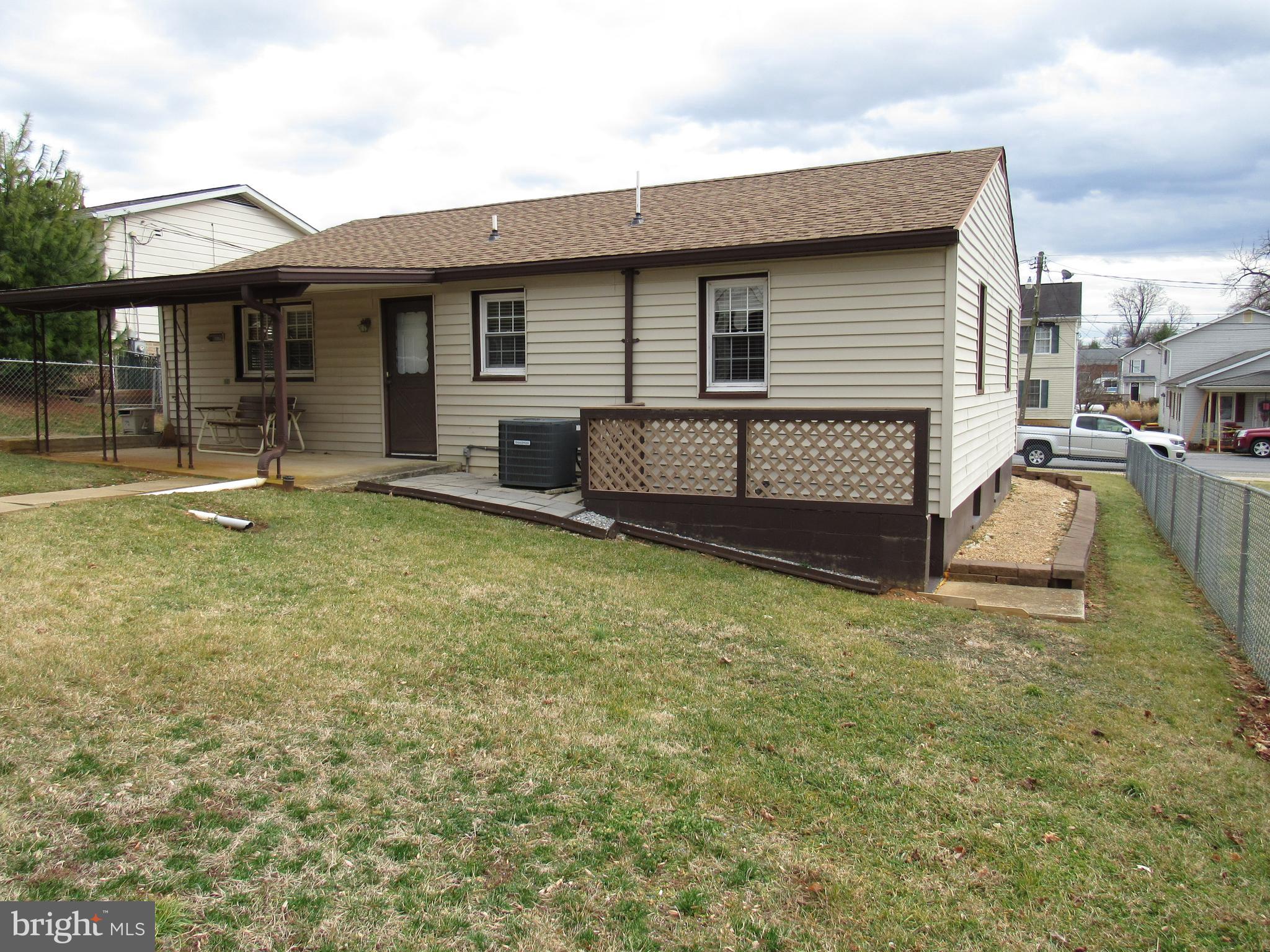 110 West 6th Avenue Ranson, WV 25438 - Photo 5 of 27 a view of a house with a backyard and a patio
