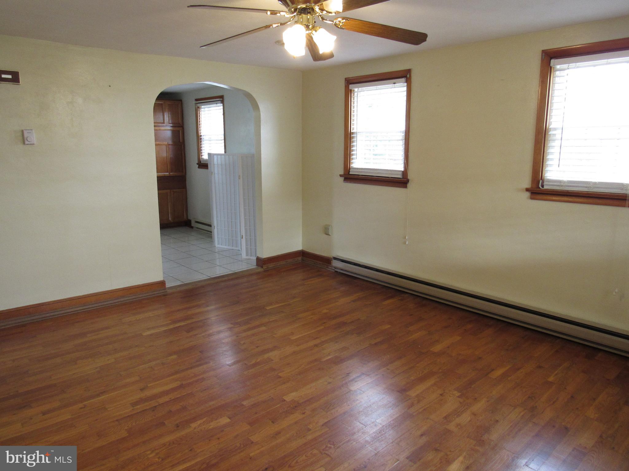 110 West 6th Avenue Ranson, WV 25438 - Photo 7 of 27 a view of an empty room with wooden floor and a window