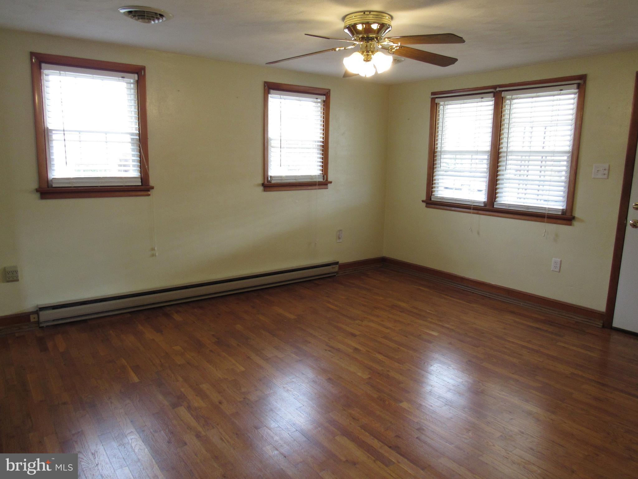 110 West 6th Avenue Ranson, WV 25438 - Photo 8 of 27 a view of an empty room with wooden floor and a window