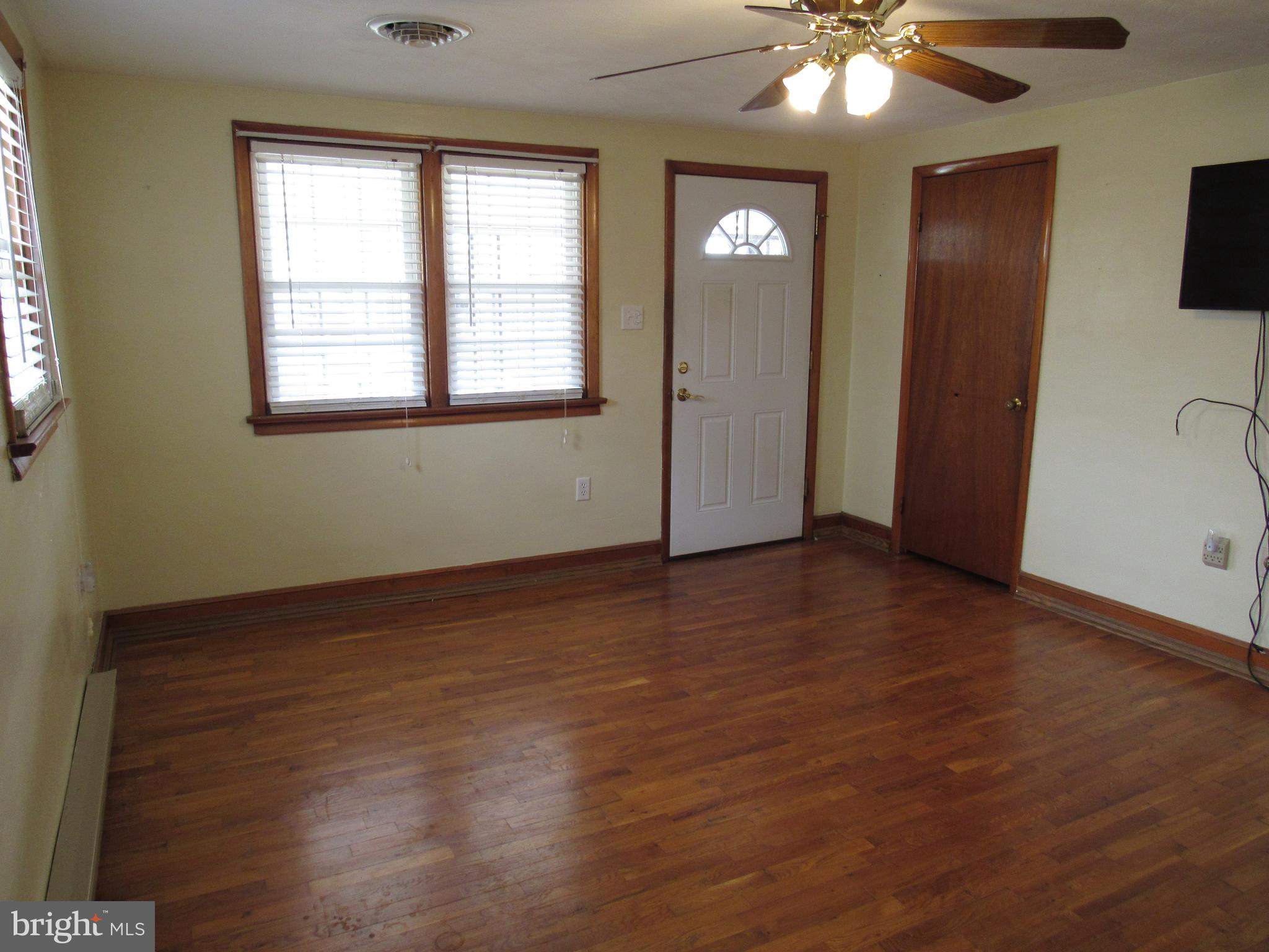 110 West 6th Avenue Ranson, WV 25438 - Photo 9 of 27 an empty room with wooden floor and windows