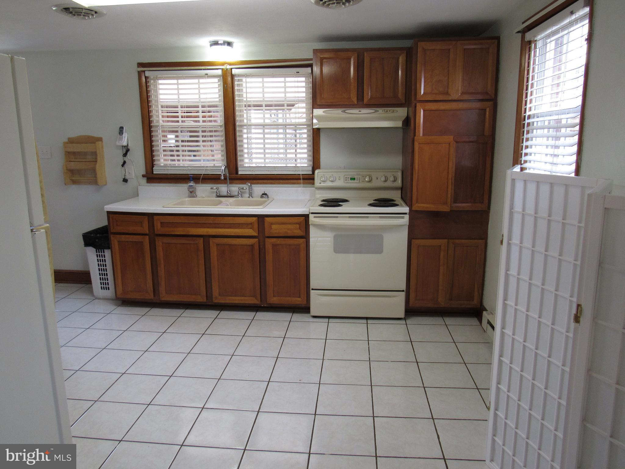 110 West 6th Avenue Ranson, WV 25438 - Photo 10 of 27 a kitchen with stainless steel appliances granite countertop a sink and a stove next to a window
