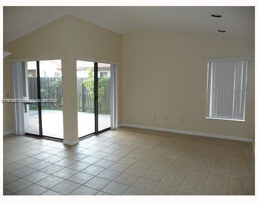 4860 Southwest 152nd Place, Unit F92 Miami, FL 33185 - Photo 2 of 6 a view of an empty room and window
