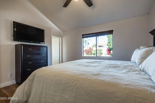 a bedroom with a bed and a flat screen tv