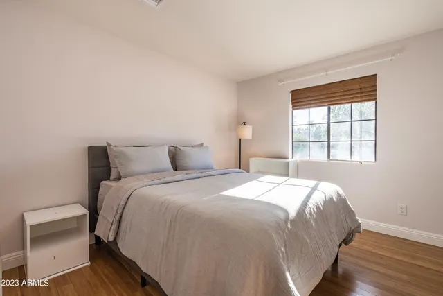 a bedroom with a bed and a window