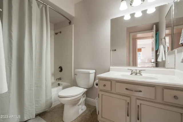 a bathroom with a toilet a sink and a mirror
