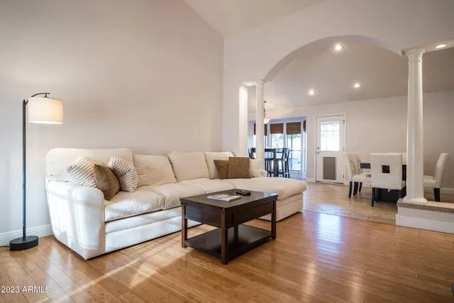 a living room with furniture and wooden floor
